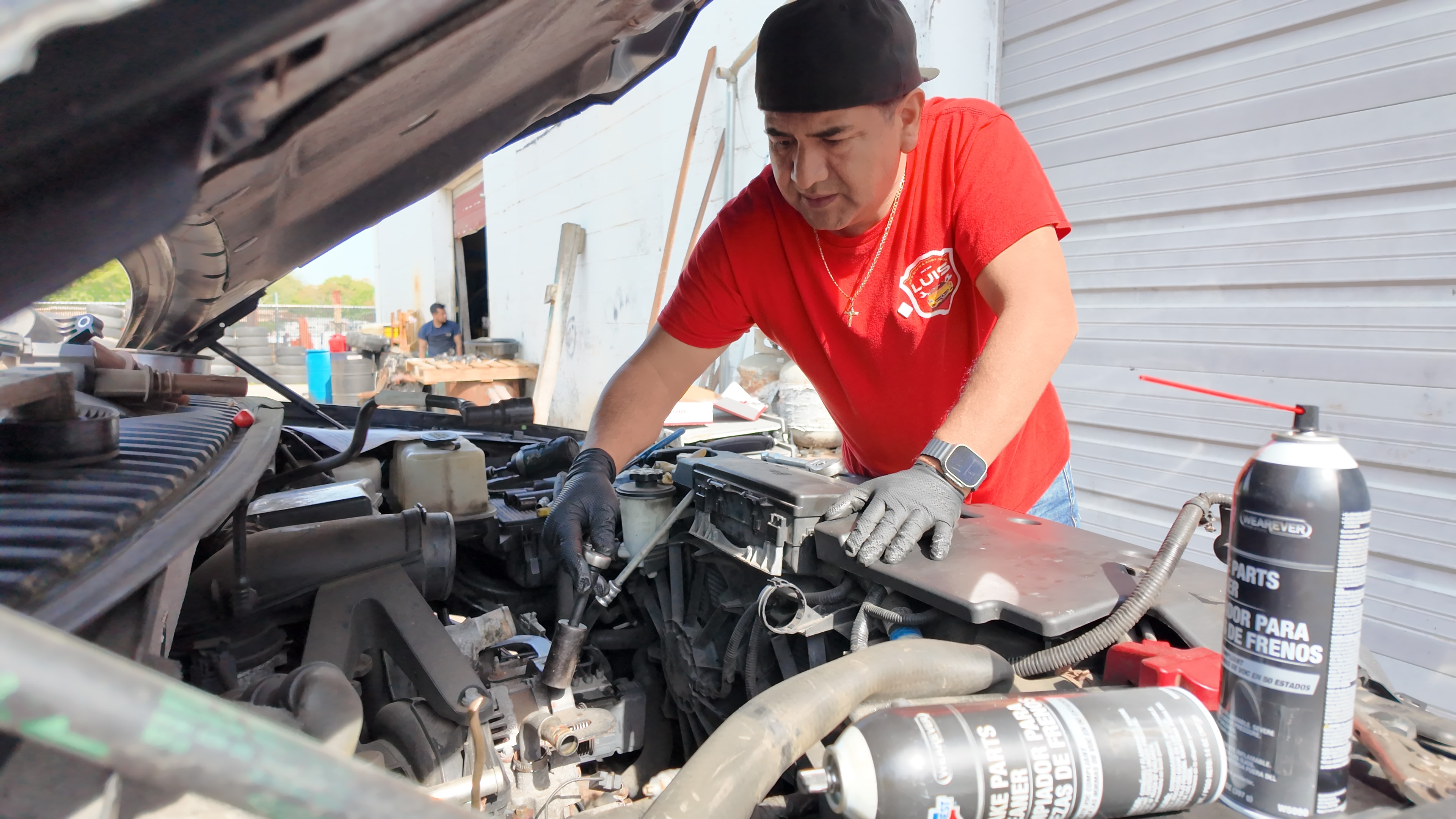 Mechanic repairing a car engine under the hood