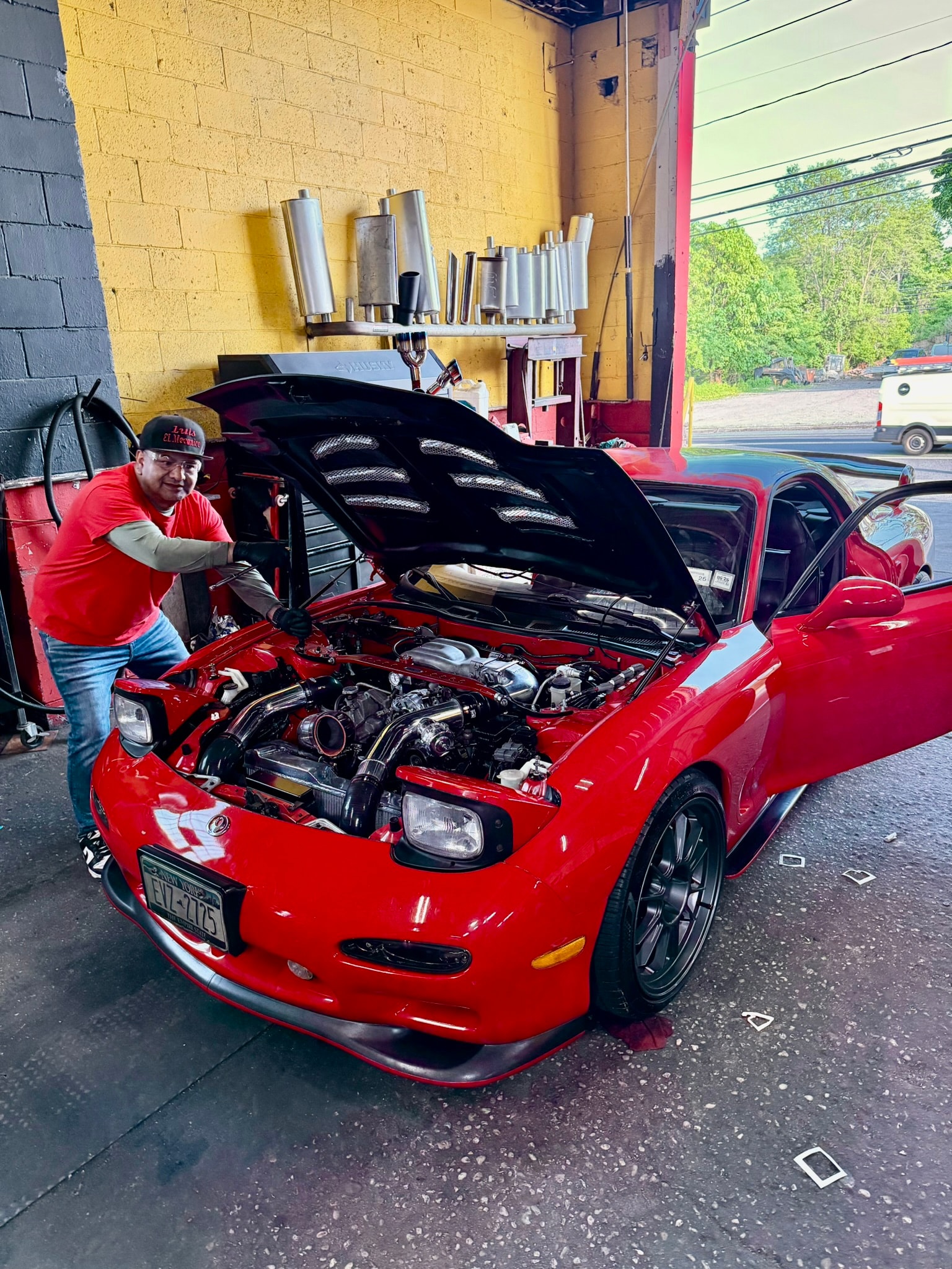 Mechanic working on a classic car engine during restoration