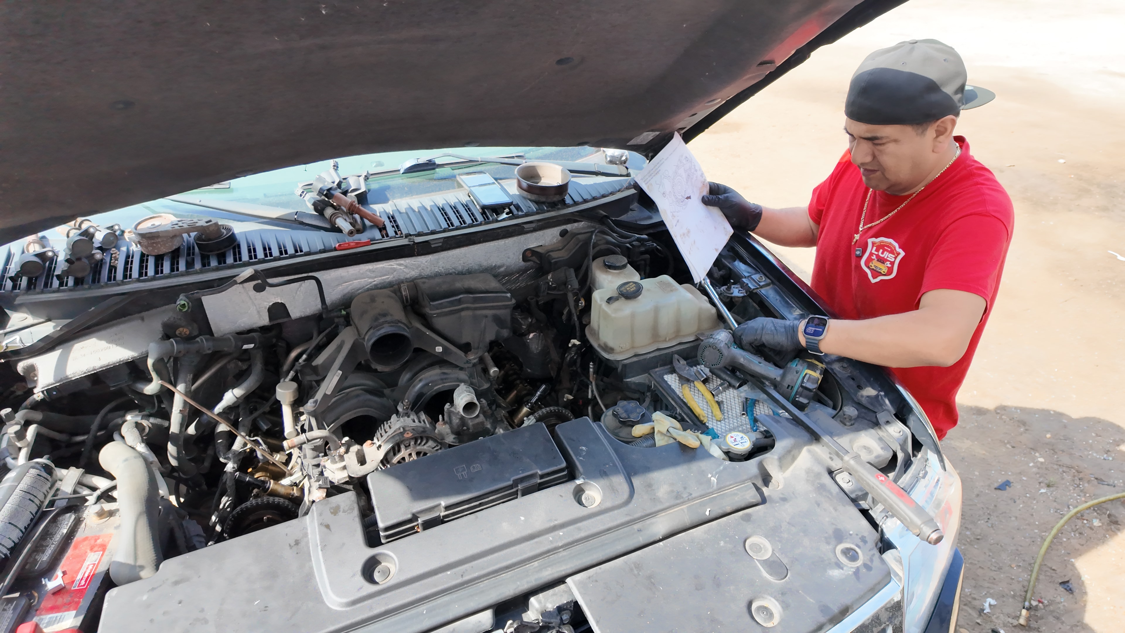 Computer diagnostics being run on a car engine with a laptop