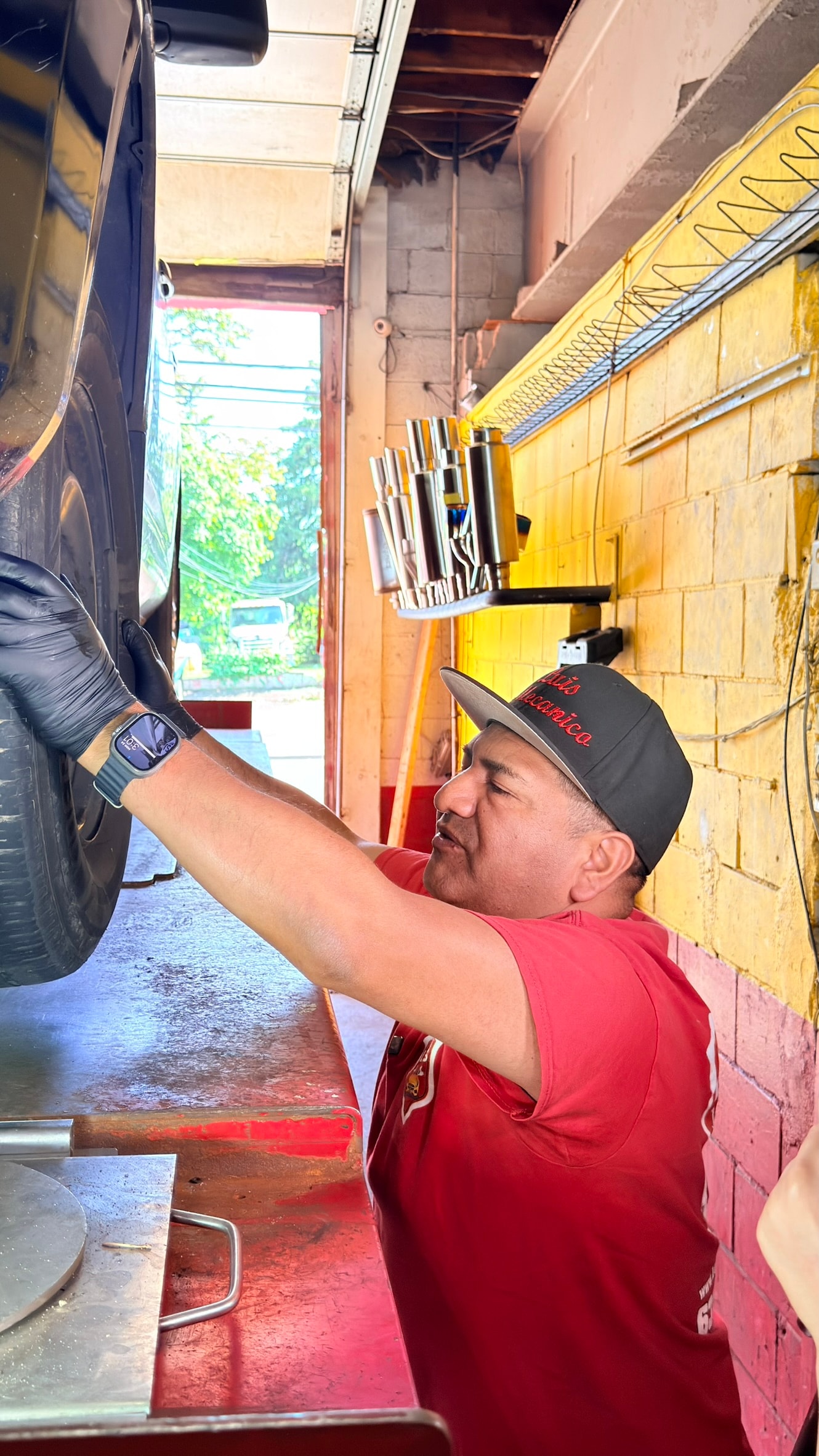 A technician at Luis Auto Repair working on a customer's vehicle